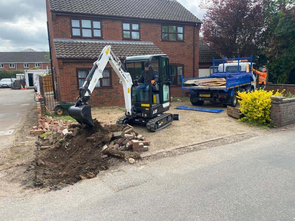 This is a photo of an operative of Ashford Driveways Digging out for a new tarmac driveway