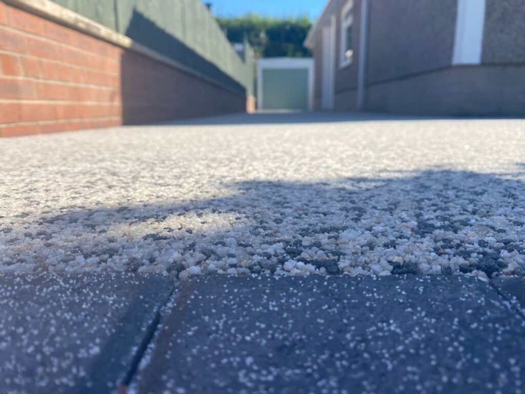 This is a close up photo showing resin installed on a driveway
