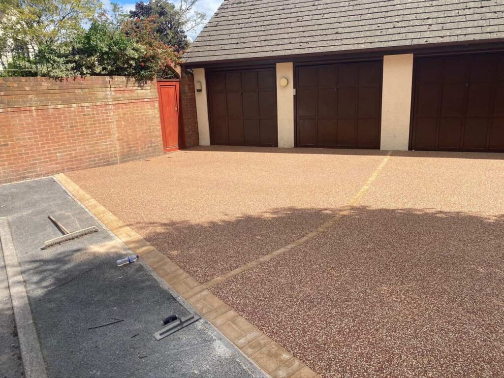 This is a photo of a resin driveway installed in front of a triple garage