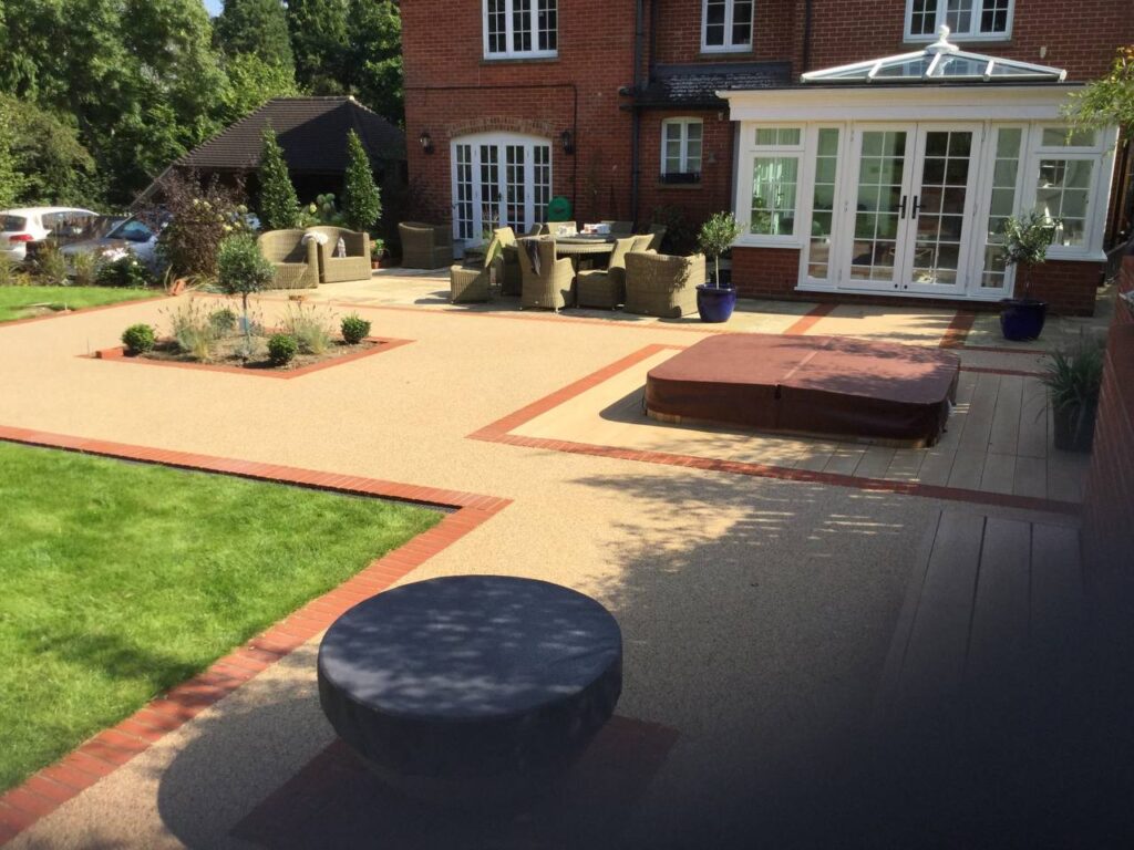 This is a photo of a resin patio installed with a brick border